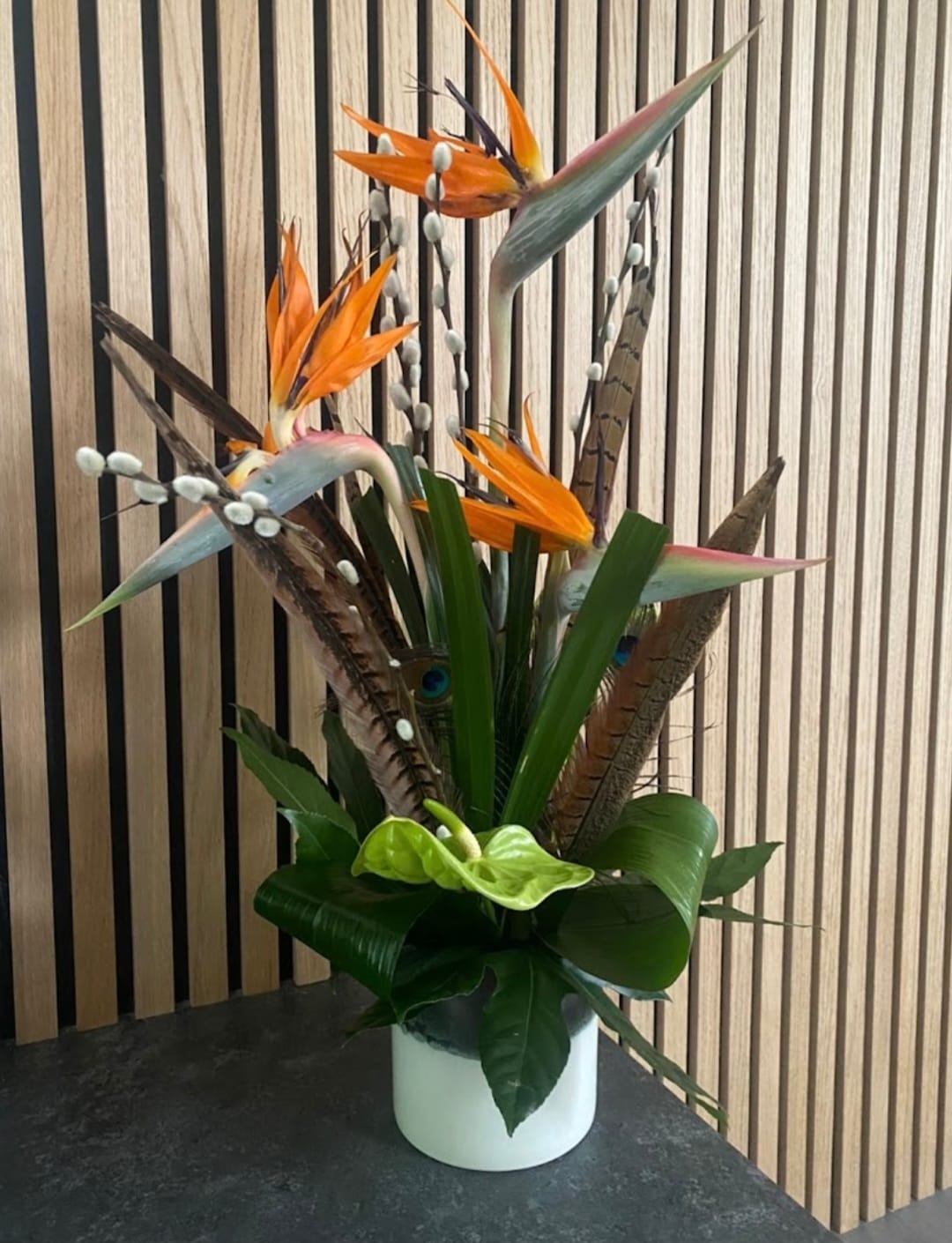 Modern Arrangement featuring tropical Birds of Paradise and feathers