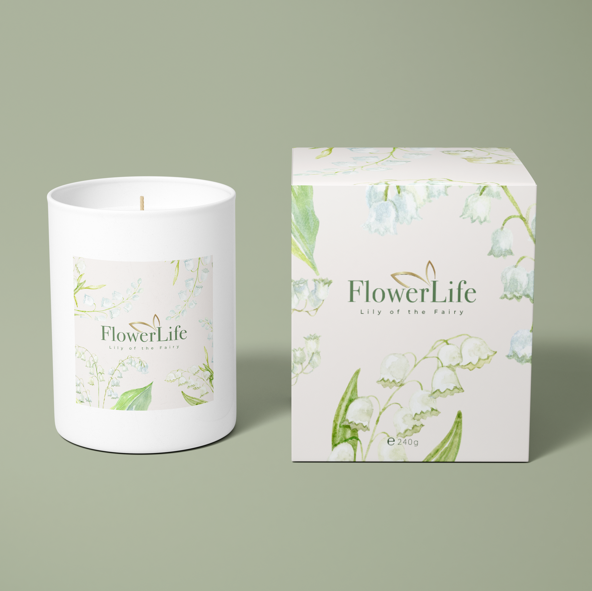 Lily of the Fairy FlowerLife scented candle and packaging on a green background