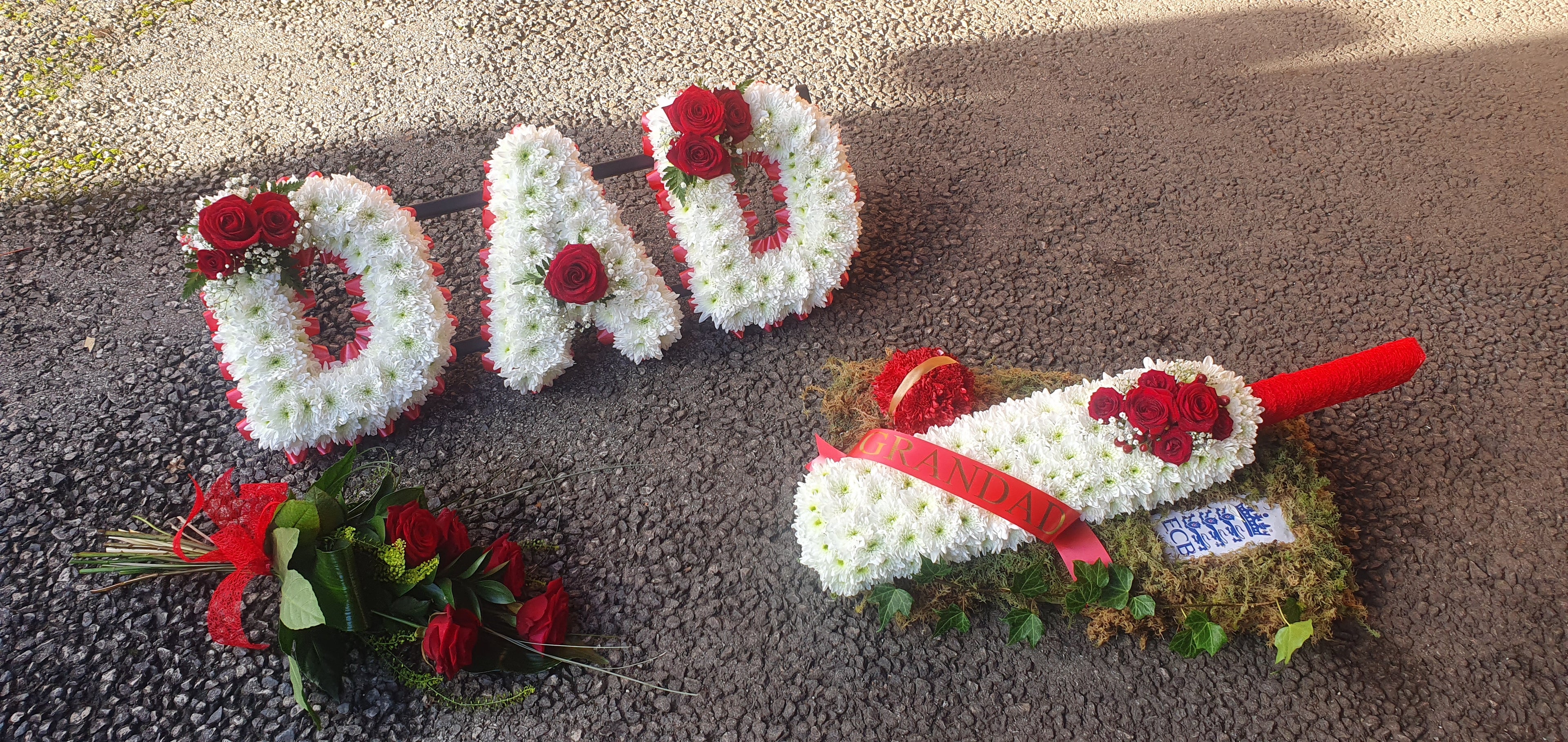 Cricket Funeral tributes includes a red rose sheaf, a floral cricket bat and Dad letters