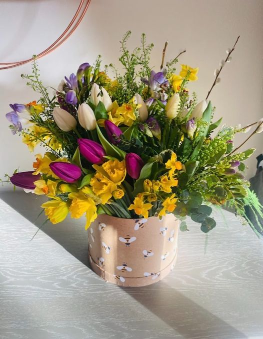 Hat Box Arrangement including a colourful variety of spring flowers